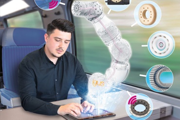 Mann arbeitet mit Tablet im Zug und animiert Roboterarm